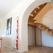 wooden staircase, arch and white walls