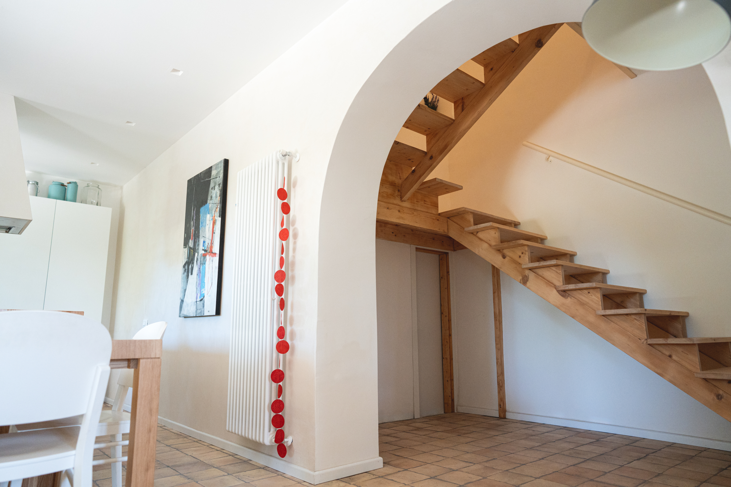 wooden staircase, arch and white walls