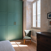 bedroom with wardrobe, window and armchair